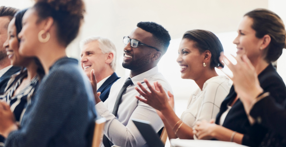 Group of office workers clapping
